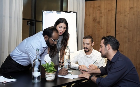 4 professionals discussing strategy for digital marketing campaign